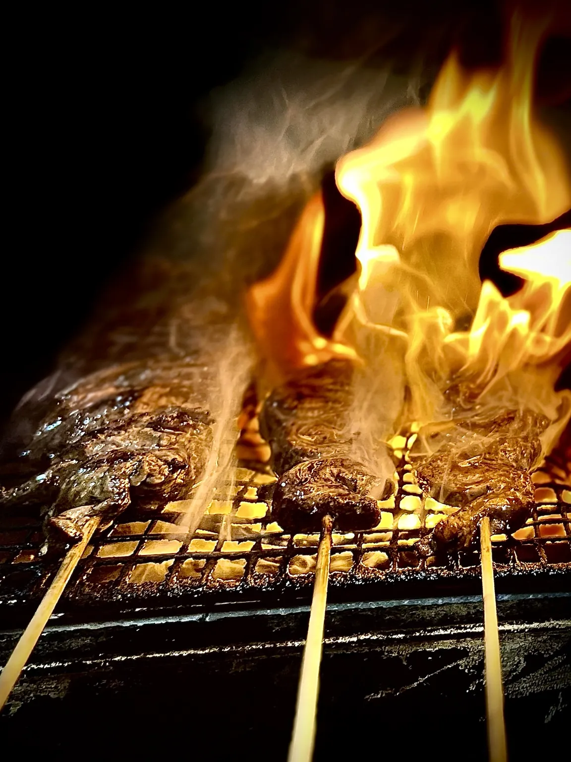 Anticuchos sizzling on the live-fire robata grill